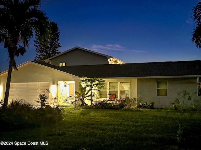 379 Hiawatha Way, Melbourne Beach, FL 32951 - view of front of property with stucco siding, a garage, and a front yard