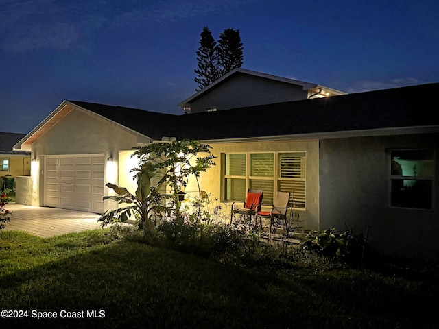 379 Hiawatha Way, Melbourne Beach, FL 32951 - view of front of property with a garage, decorative driveway, stucco siding, and a lawn