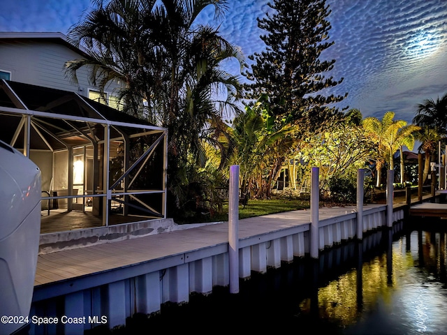 exterior space featuring a water view and glass enclosure