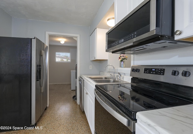 kitchen featuring white cabinets, washer / dryer, sink, and appliances with stainless steel finishes