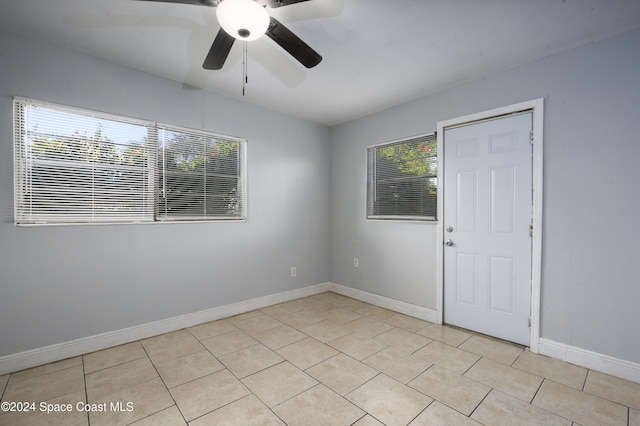 empty room with a wealth of natural light and ceiling fan