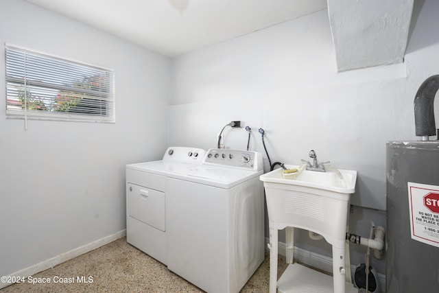 washroom with separate washer and dryer and water heater