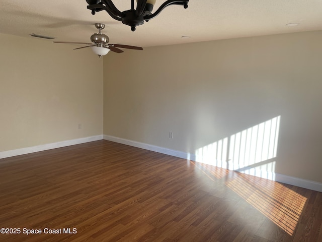 unfurnished room with ceiling fan and dark hardwood / wood-style flooring