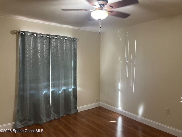 empty room featuring hardwood / wood-style floors, ceiling fan, and a textured ceiling