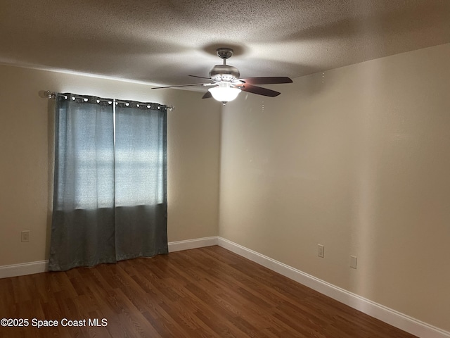 spare room featuring ceiling fan, wood-type flooring, and a textured ceiling