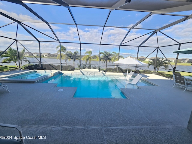 view of pool with a lanai, a patio area, an in ground hot tub, and a water view