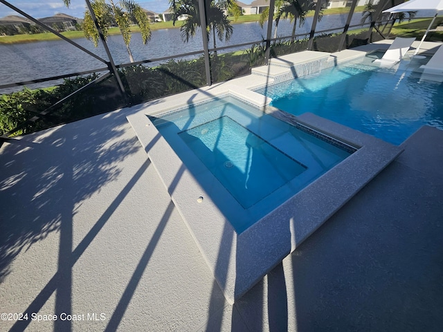 view of swimming pool with a patio and a water view