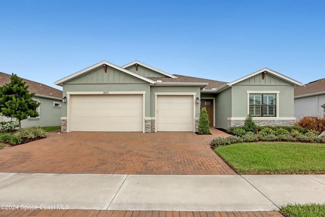 view of front of home with a garage and a front lawn