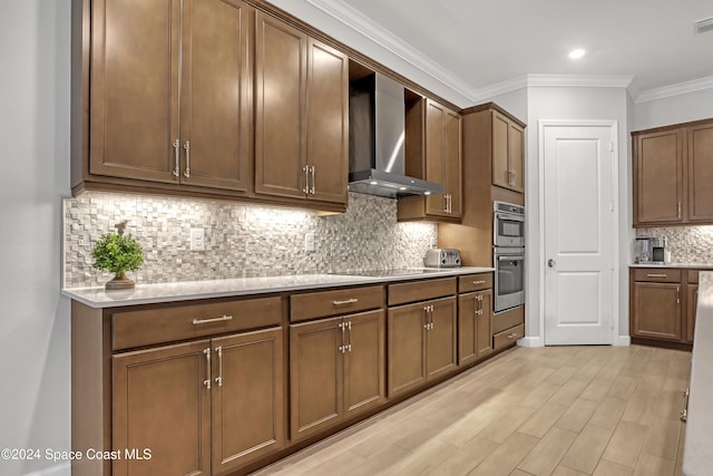 kitchen featuring backsplash, crown molding, wall chimney exhaust hood, black electric cooktop, and stainless steel double oven