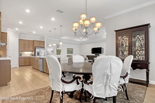 dining room featuring a chandelier, light hardwood / wood-style floors, and ornamental molding