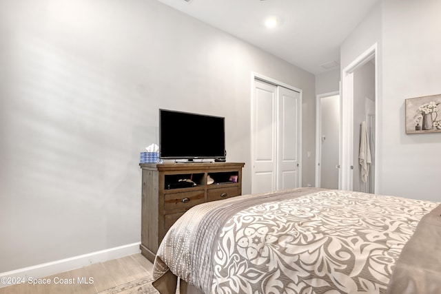 bedroom featuring a closet and light hardwood / wood-style floors