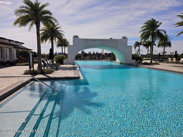 view of pool with a patio area and a water slide