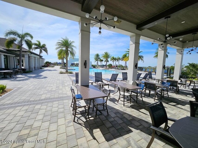 view of patio featuring ceiling fan and a community pool