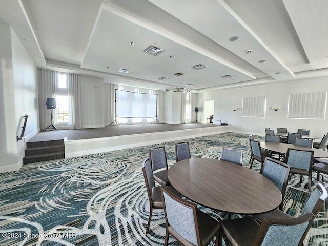 dining area with a raised ceiling