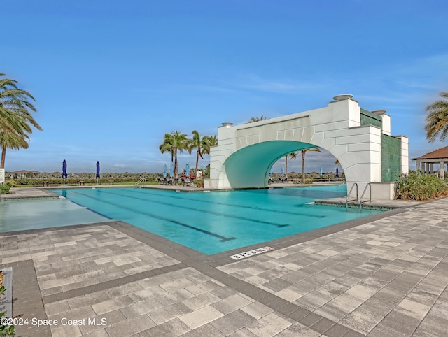 view of pool featuring a patio and a water slide