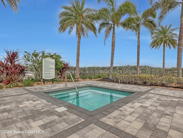 view of pool with a hot tub