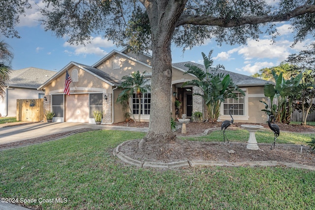 view of front of house with a front yard and a garage