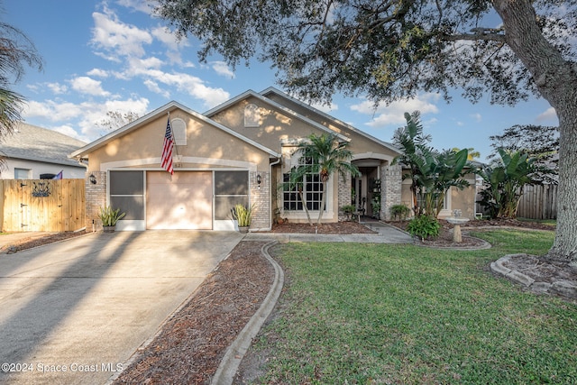 ranch-style home with a garage and a front yard