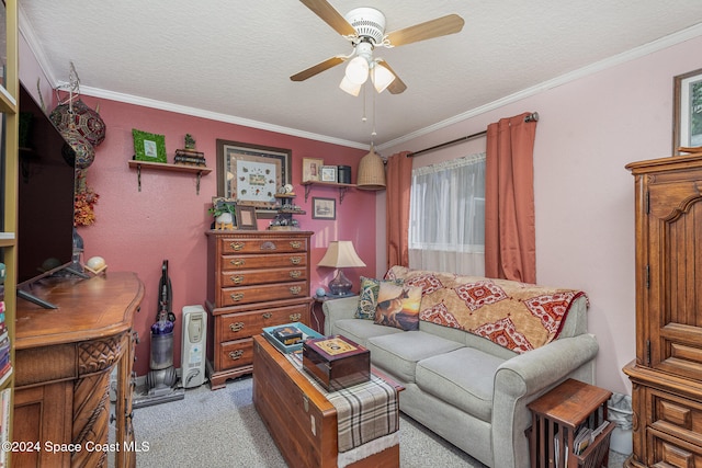 living room with ceiling fan, light colored carpet, a textured ceiling, and ornamental molding