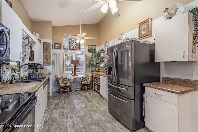 kitchen with stainless steel fridge with ice dispenser, white cabinetry, and sink