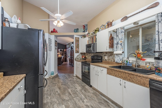 kitchen featuring black appliances, white cabinets, sink, and hardwood / wood-style flooring