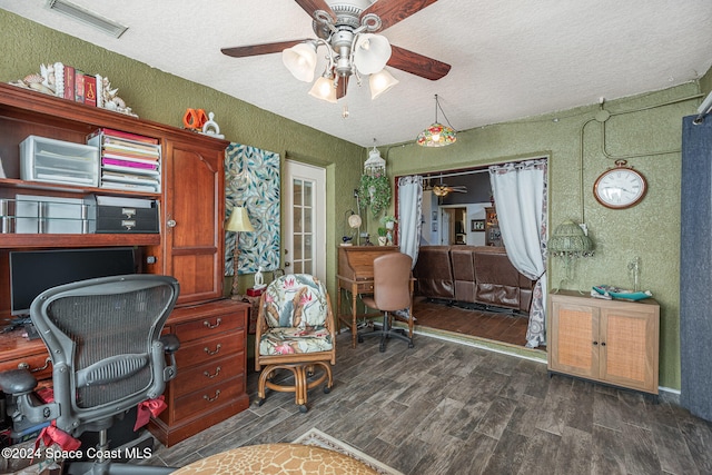 home office with a textured ceiling, ceiling fan, and dark wood-type flooring