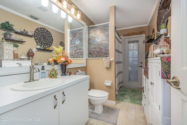 bathroom featuring vanity, a textured ceiling, toilet, and ornamental molding