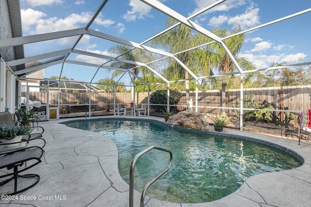 view of pool featuring a patio and glass enclosure