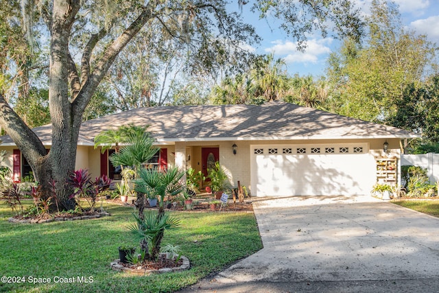 ranch-style home with a garage and a front lawn