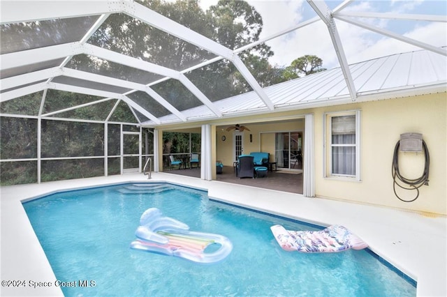 view of swimming pool with a lanai, a patio area, ceiling fan, and an outdoor hangout area