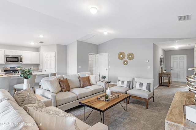 carpeted living room featuring lofted ceiling