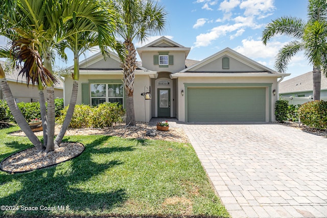 view of front of house featuring a front yard and a garage