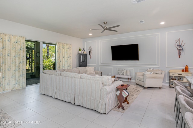 living room with ceiling fan and light tile patterned flooring