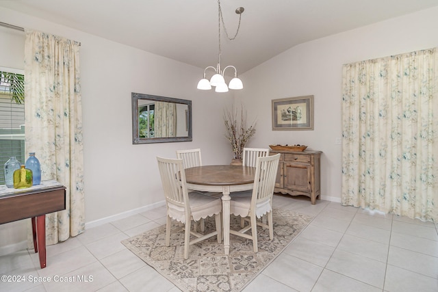 tiled dining room with lofted ceiling and a notable chandelier