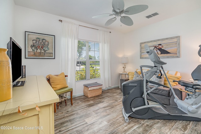 workout area featuring wood-type flooring and ceiling fan