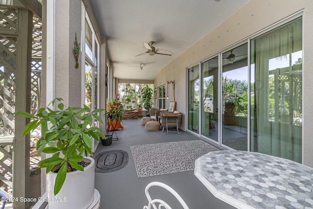 sunroom featuring ceiling fan