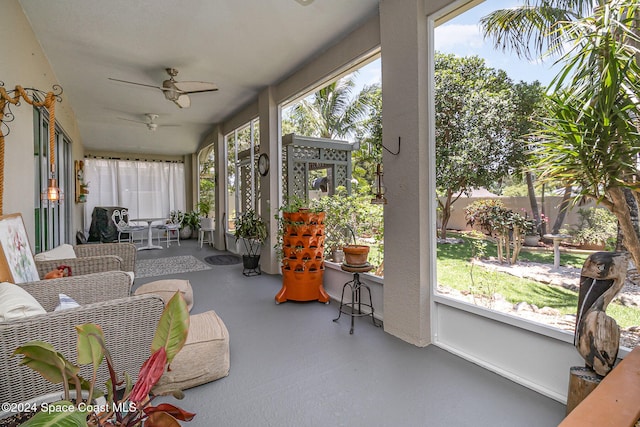 sunroom / solarium featuring a wealth of natural light and ceiling fan