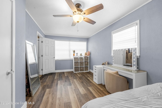 bedroom with ceiling fan, dark hardwood / wood-style flooring, ornamental molding, and a textured ceiling