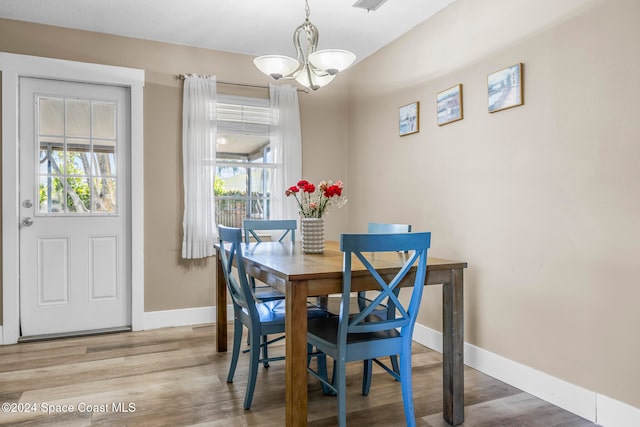 dining space featuring a chandelier and hardwood / wood-style flooring