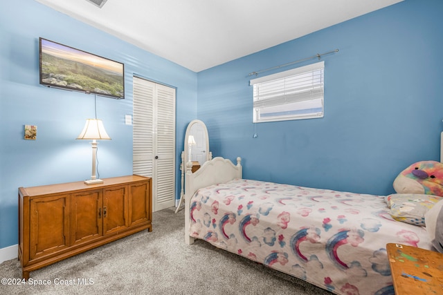 bedroom featuring a closet and light colored carpet