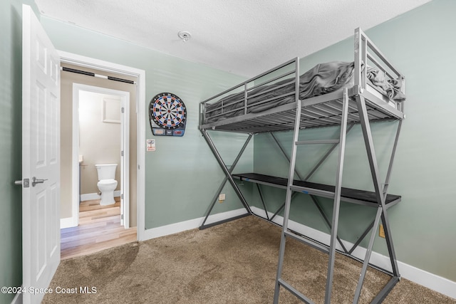 unfurnished bedroom featuring a textured ceiling and hardwood / wood-style flooring