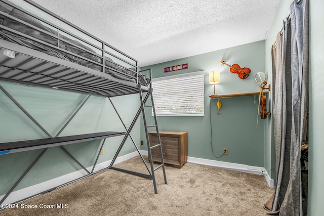 bedroom with carpet floors and a textured ceiling