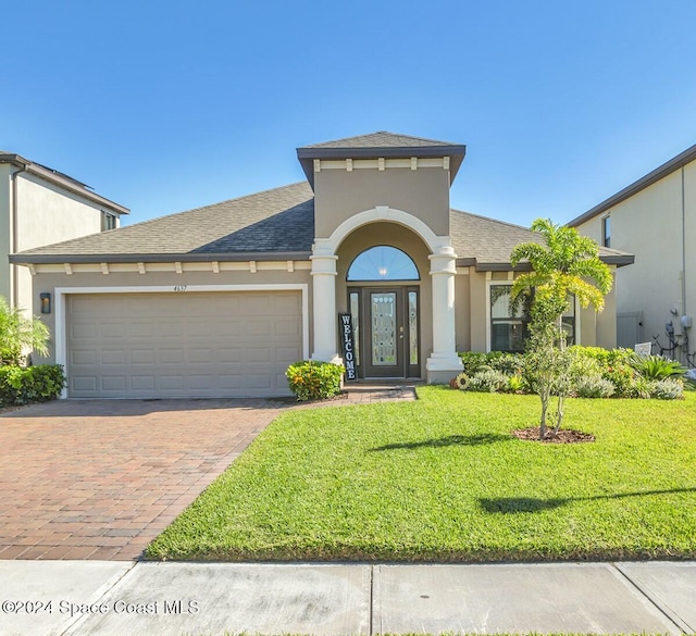 view of front facade with a garage and a front yard