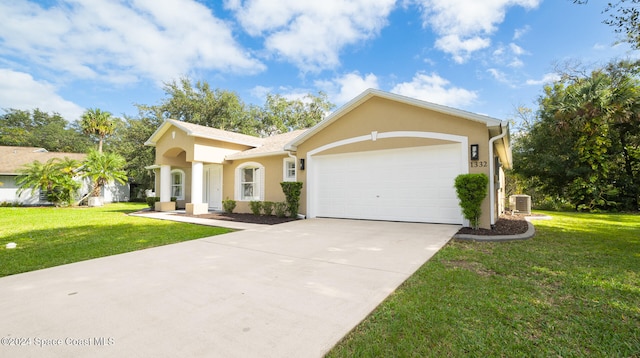 view of front facade with cooling unit, a front lawn, and a garage