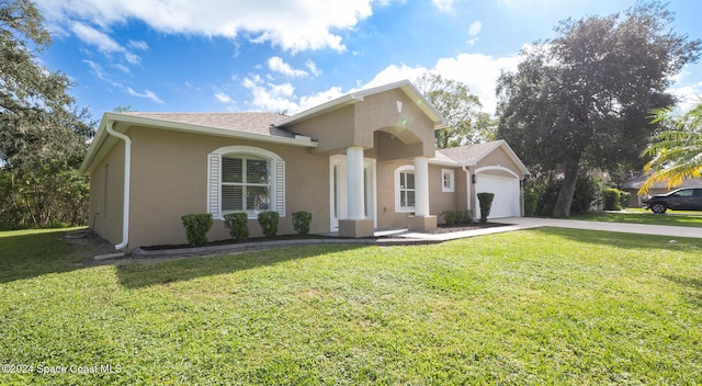 view of front of property featuring a garage and a front yard