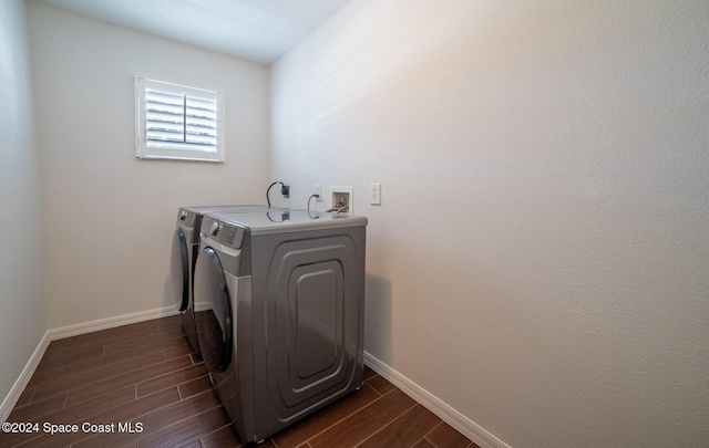 laundry area with washing machine and dryer and dark hardwood / wood-style floors