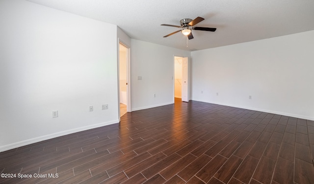 empty room featuring ceiling fan and dark wood-type flooring