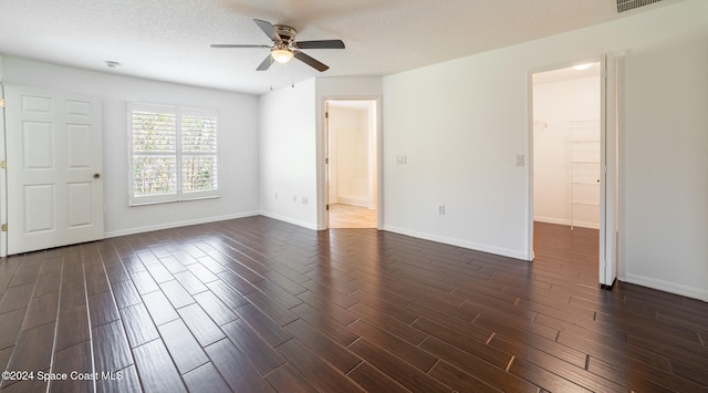 spare room with ceiling fan, dark hardwood / wood-style flooring, and a textured ceiling