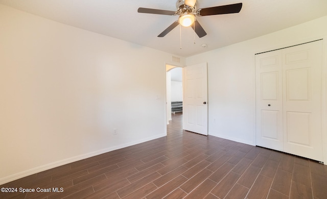 unfurnished bedroom featuring dark hardwood / wood-style flooring, a closet, and ceiling fan