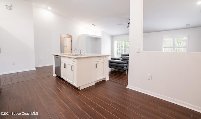 kitchen with dark hardwood / wood-style flooring, a wealth of natural light, sink, and white cabinets